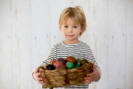 Sweet toddler child, cute boy playing with colorful easter eggs, studio shotの写真素材
