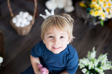 Beaufitlu toddler blond boy, wearing little crown, pretending to be prince, child playing imaginary gamesの写真素材