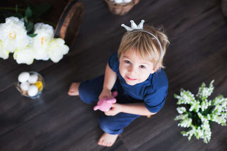 Beaufitlu toddler blond boy, wearing little crown, pretending to be prince, child playing imaginary gamesの写真素材