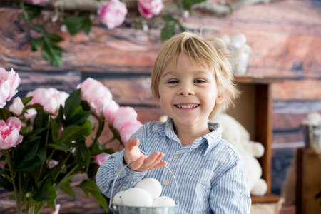 Cute toddler blond child, boy with easter decoration in studio