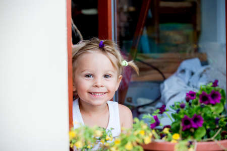 Cute portrait of a sweet blond toddler child in garden, summertimeの写真素材