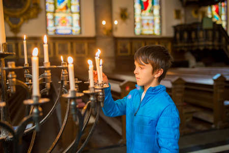Little child, boy, praying in church, cathedrale in Stockholm, Swedenの写真素材