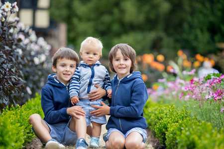 Beautiful child in amazing flower garden, summertimeの写真素材