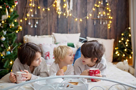 Happy family with children and pet dog, enjoying Christmas time together, celebrating christmasの写真素材