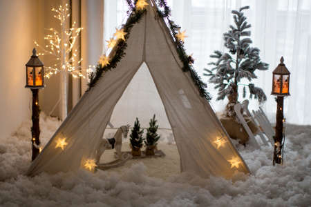 Winter scene with teepee, light tree, christmas tree and street lamps. Snowy decorの写真素材