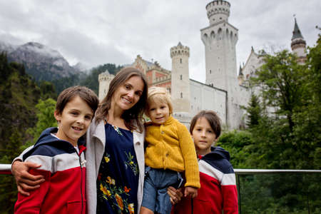 People, enjoying a day in Neuschwanstein castle in Germany, summertime on a cloudy foggy dayの写真素材