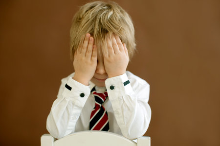Cute toddler child, boy with smart casual clothing on isolated background, showing different emotions, studio shotの写真素材