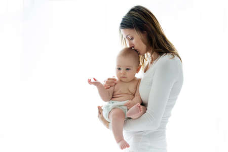 Mother, holding her sick baby boy, sad baby, isolated on white background