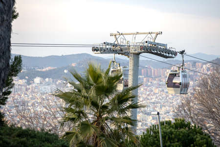 Cable car lift in Barcelona city. Springtime, cabin connecting Montujic and the city under, Spain