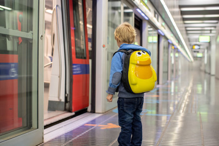Children, traveling on the subway early in the morning, empty train, Barcelona , Spain