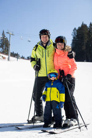 Happy family, skiing in Italy on a sunny day, kids and adults skiing together. Family vacationの写真素材