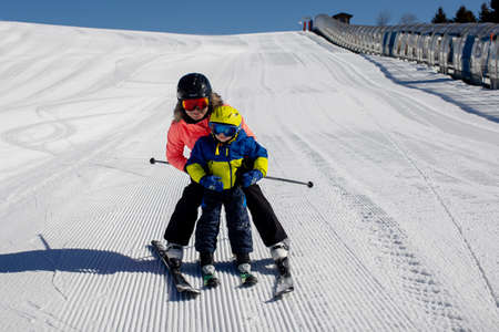 Happy family, skiing in Italy on a sunny day, kids and adults skiing together. Family vacationの写真素材