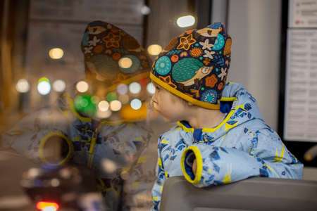 Cute little child tourists admiring Barcelona city from bus window at night, family travel with kids in Spainの写真素材