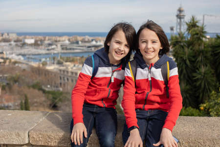 Cute little children tourists admiring Barcelona city, family travel with kids in Spainの写真素材