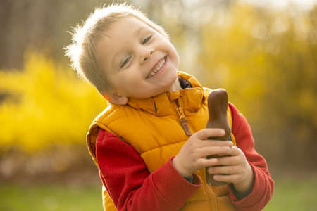 Cute preschool child, boy, holding handmade braided whip made from pussy willow, traditional symbol...