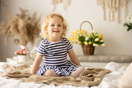 Happy children, siblings, enjoying Easter holiday together, tradition with handmade twig, braided...
