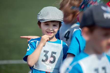 Young preschool children, running on track in a marathon competition, radial blurred motionの写真素材