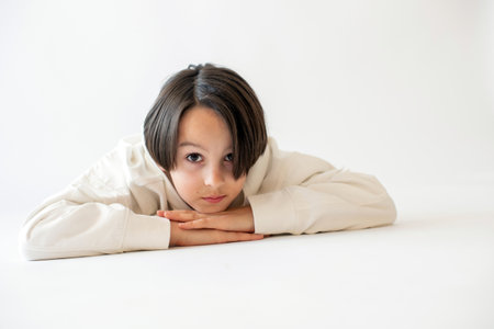 Cute stylish toddler child and older brothers, boys with white shirts on white background, family kids portrait, studio shotの写真素材