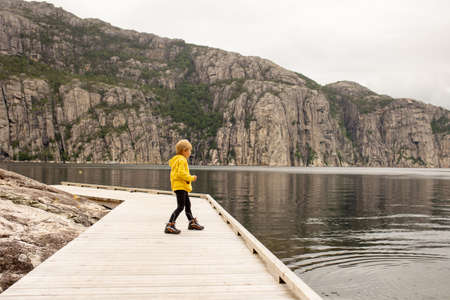 Family, children, adults and dog, enjoying the beach in Forsand, Lysebotn on a cloudy dayの写真素材