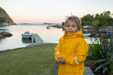 Family visiting town Mandal in Norway, enjoying amazing views, kids playing on sunset
