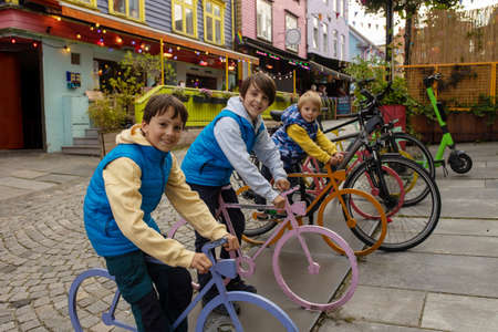 Happy family, children and adults, enjoying the colorful city of Stavangen in Southwest Norway on a...