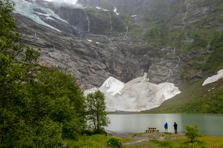 People enjoying the amazing view of the glacier in Jostedalsbreen national parkの写真素材