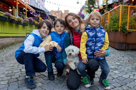 Happy family, children and adults, enjoying the colorful city of Stavangen in Southwest Norway on a...