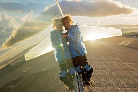 Child, blond toddler boy, hiking mount Hoven, enjoying the splendid view over Nordfjord from the...