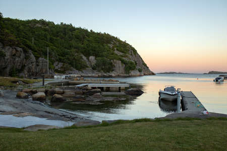Beautiful sunset over a fjord with boats. Amazing nature in Norway