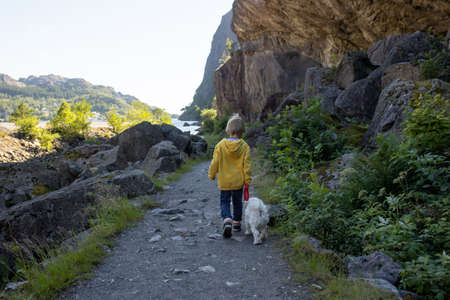 Happy people, enjoying amazing views in South Norway coastline, fjords, lakes, beautiful nature. Kids and adults traveling in Norway summertimeの写真素材