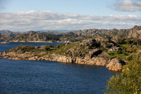 Happy people, enjoying amazing views in South Norway coastline, fjords, lakes, beautiful nature. Kids and adults traveling in Norway summertimeの写真素材