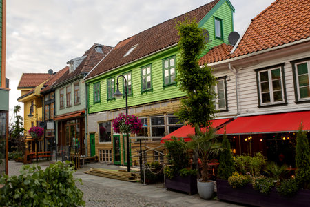 Happy family, children and adults, enjoying the colorful city of Stavangen in Southwest Norway on a summer eveningのeditorial素材
