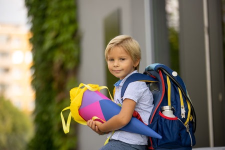 Cute blond child, boy with candy cone on first school day in Czech Republic, old German tradition that what transfer to Czzech as wellの写真素材