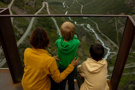 Family, children and adults, visiting the famous Trollstigen road in Norwayの写真素材
