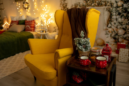 Empty yellow armchair in a decorated room for Christmas, cozy placeの写真素材