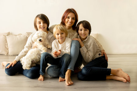 Happy family with three kids and dog, sitting at home at Christmas, cozy atmosphere, Christmas timeの写真素材