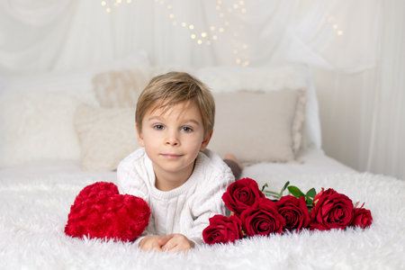 Valentine portrait of a little cute child with hearts, roses and signの写真素材
