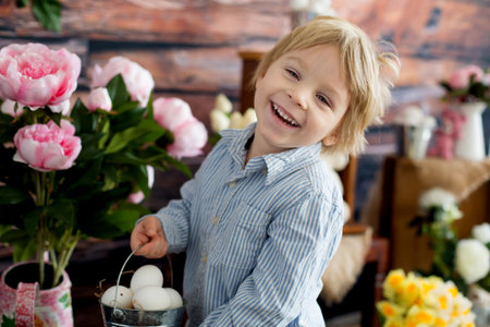 Cute toddler blond child, boy with easter decoration in studio