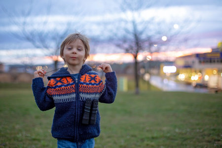 Child, watching amazing sunset with binoculars springtimeの写真素材