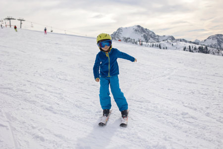 Happy family, enjoying ski holiday with children, sunny beautiful weather outdoorsの写真素材
