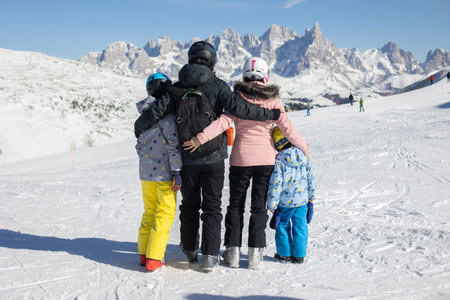 Happy family, enjoying ski holiday with children, sunny beautiful weather outdoorsの写真素材
