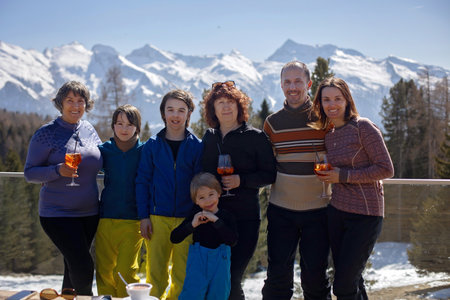 Happy family, enjoying ski holiday with children, sunny beautiful weather outdoorsの写真素材