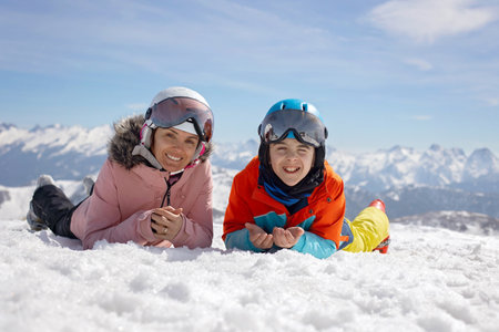 Happy family, enjoying ski holiday with children, sunny beautiful weather outdoorsの写真素材