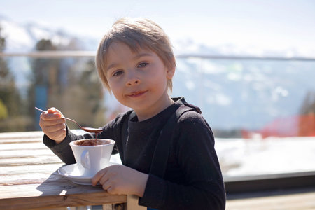 Happy family, enjoying ski holiday with children, sunny beautiful weather outdoorsの写真素材