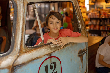 Family with kids, enjoying the Sarona Market in Tel Aviv, Israel, trying the food