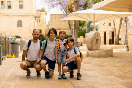 European tourist family with children, visiting Jerusalem, meeting new cultureの写真素材