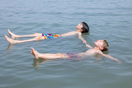 Child, boy, floating in the Dead sea on a very hot summer dayの写真素材