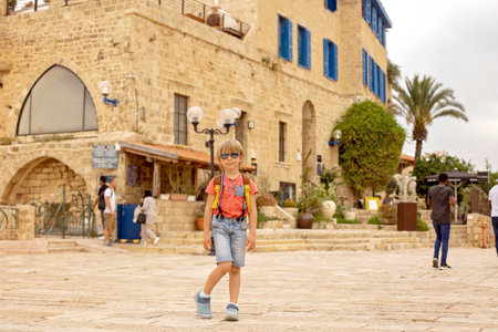 European tourist family with children, visiting Tel Aviv, Israel, enjoying day walk in the cityの写真素材