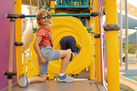 Happy children, boys, playing on playground in Tel Aviv, israel on a hot summer dayの写真素材
