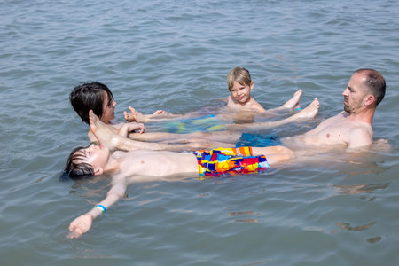 Child, boy, floating in the Dead sea on a very hot summer dayの写真素材